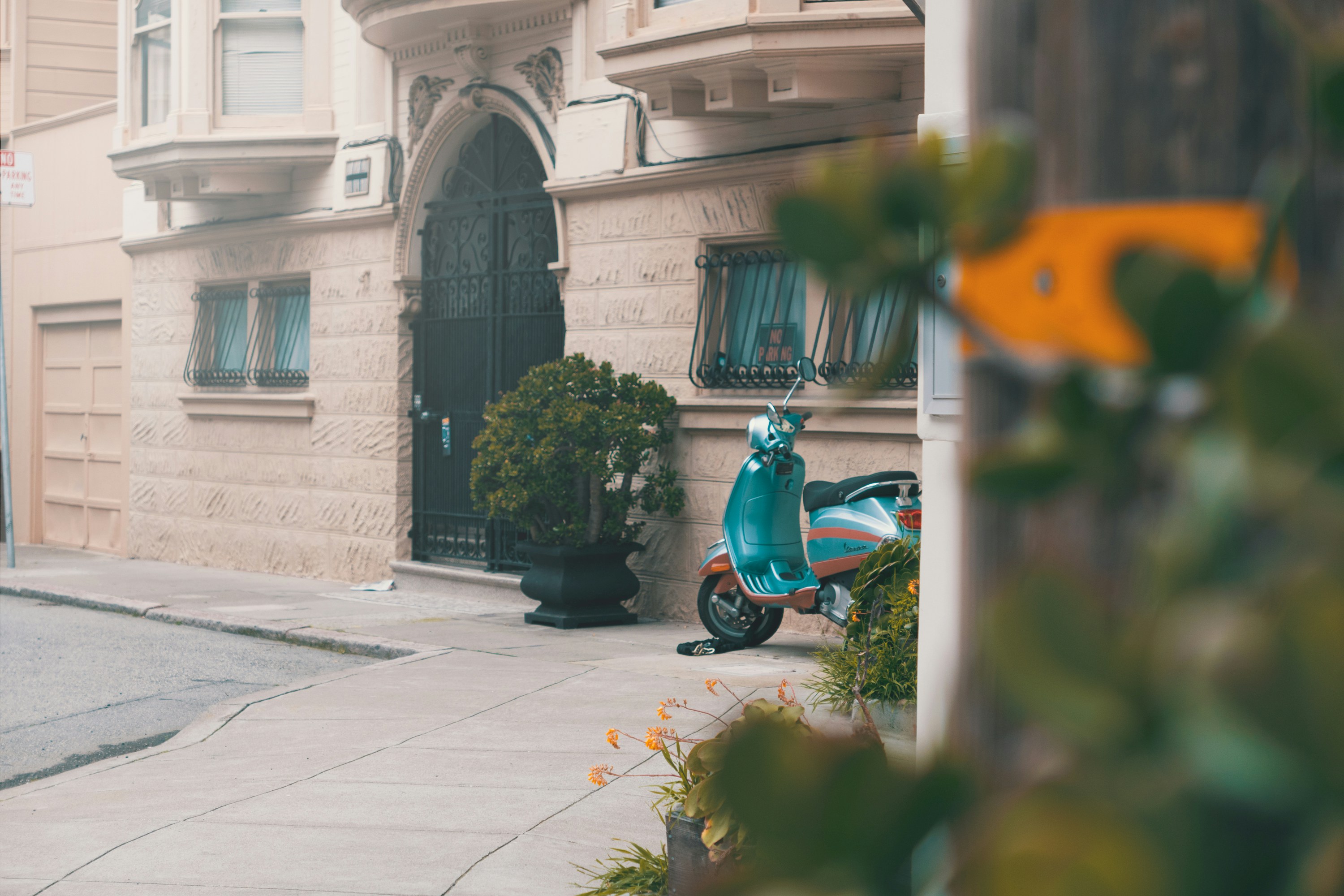 blue motor scooter parked near building, San Francisco Street