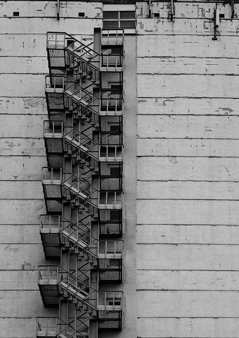 a tall building with lots of windows and balconies