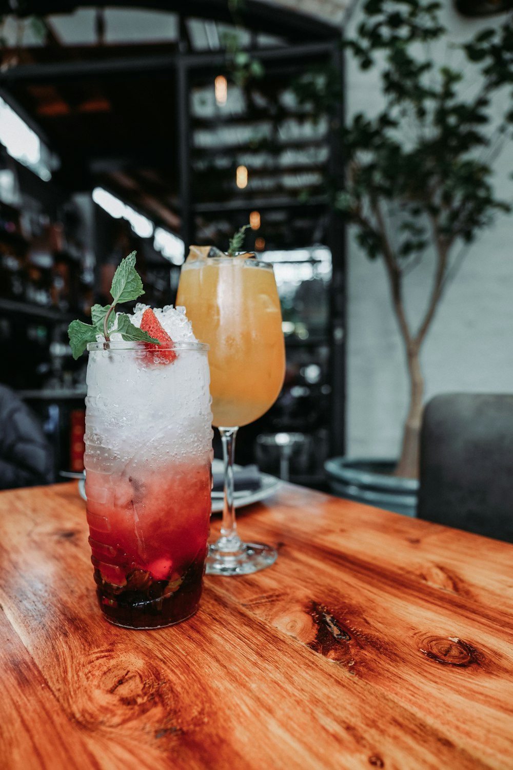 two drinks sitting on top of a wooden table