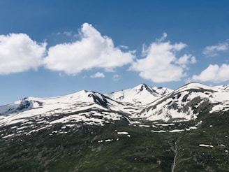 Snow-capped mountains under a clear blue sky, perfect for adventure.