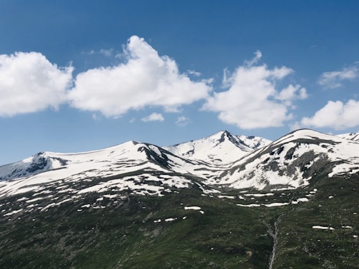 Snow-capped mountains under a clear blue sky, perfect for adventure.