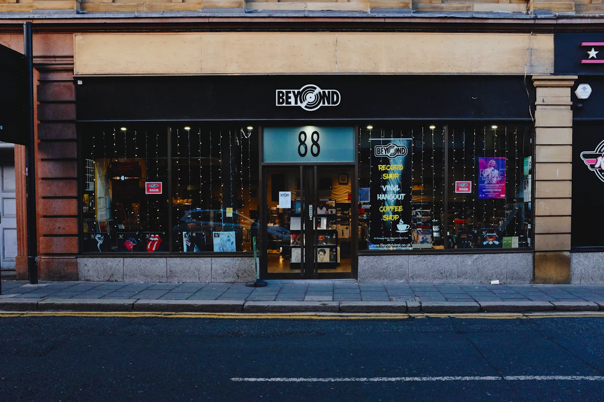 Two nearly identical small business storefronts side by side on the same street, one with a fresher sign