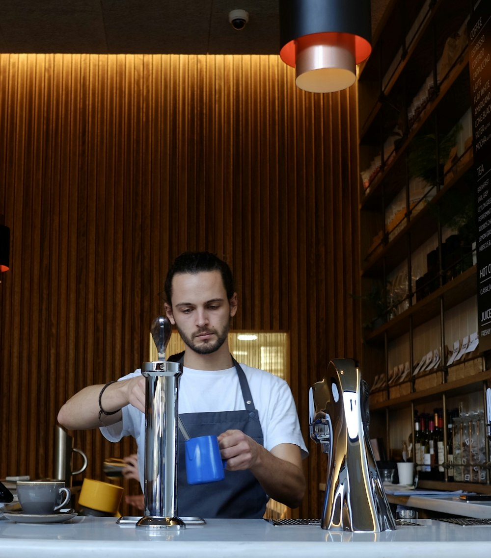 man holding blue mug