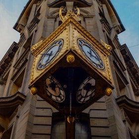 brown hanging street clock