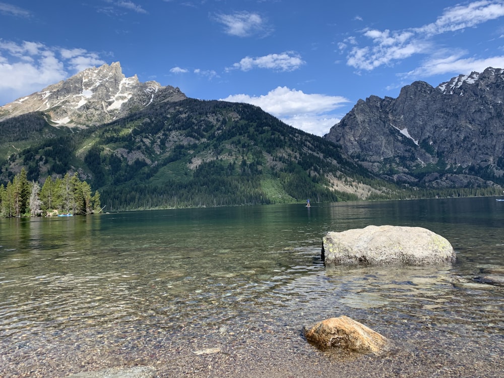 low-angle photography of blue body of water under blue sky