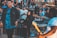 A lively outdoor concert scene with a solo musician performing on stage.