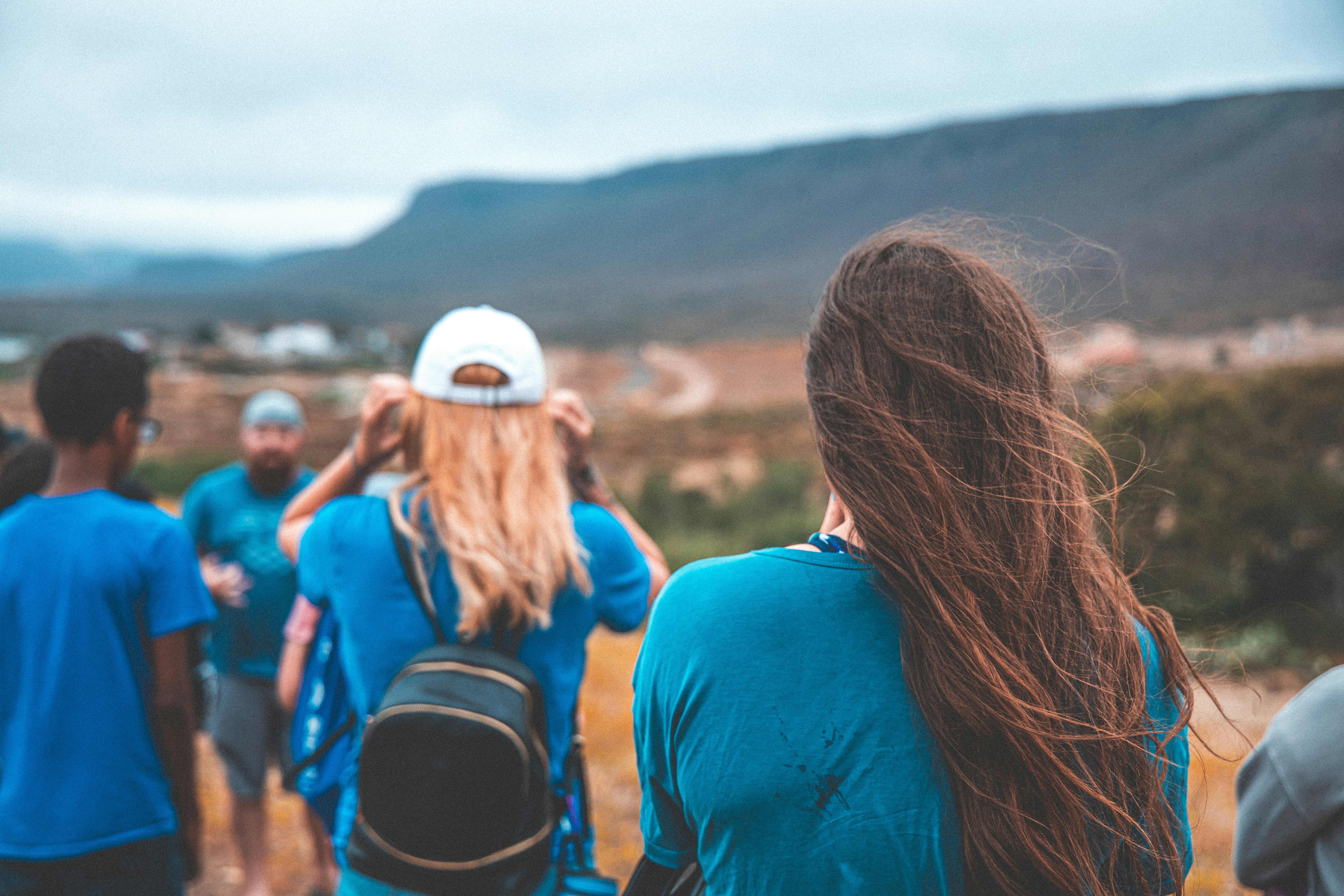 people standing near mountain during daytime