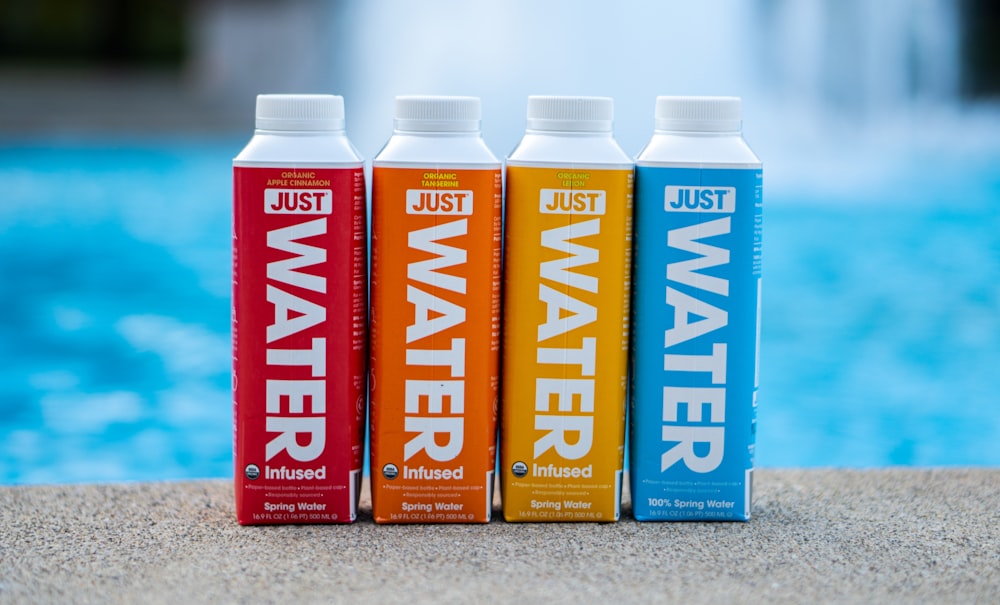 four assorted-color water bottles