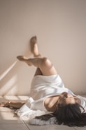 woman lying on the floor, legs up