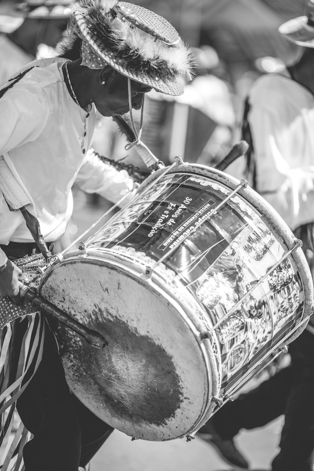 grayscale photo of man playing drum