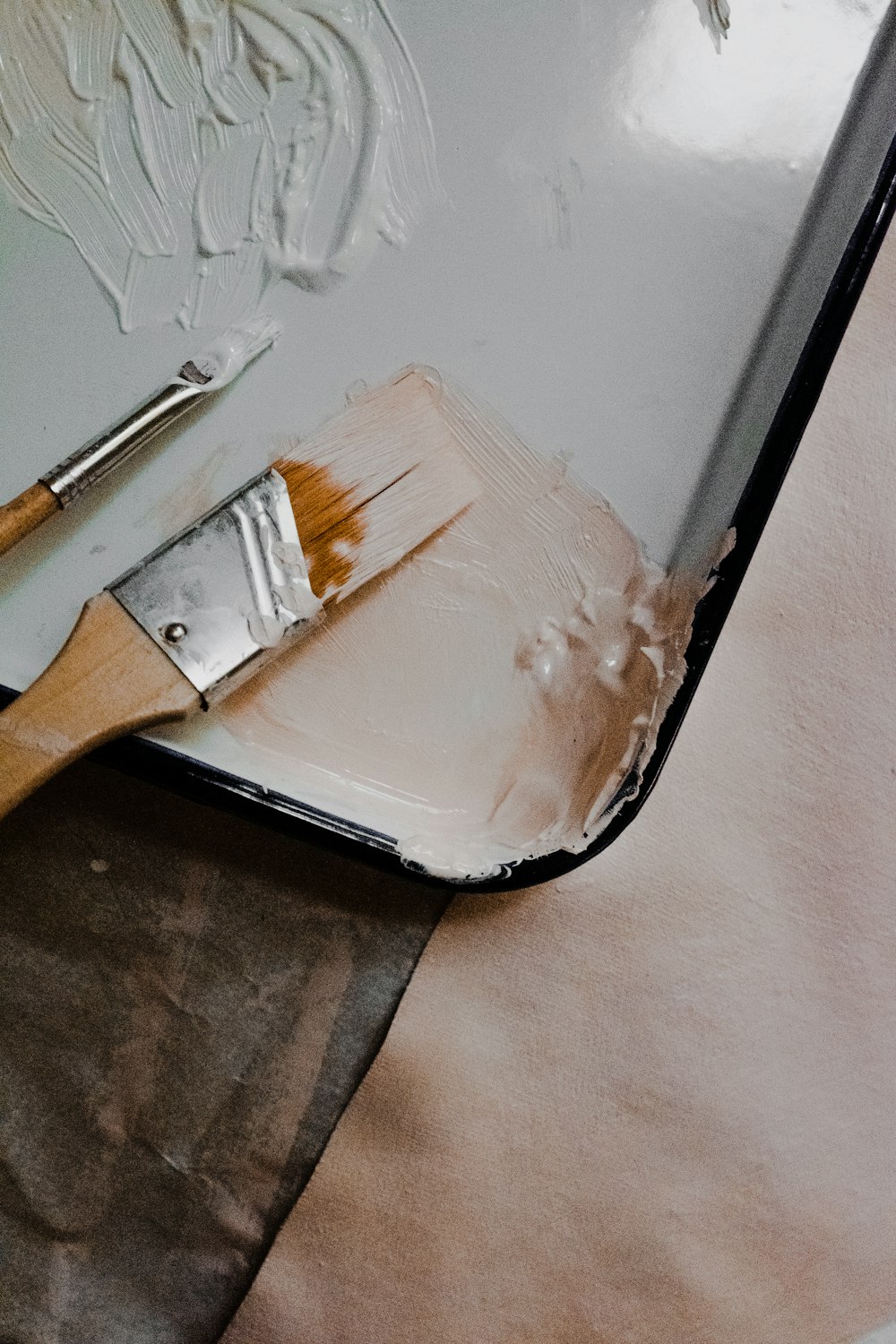 a paintbrush sitting on top of a piece of paper