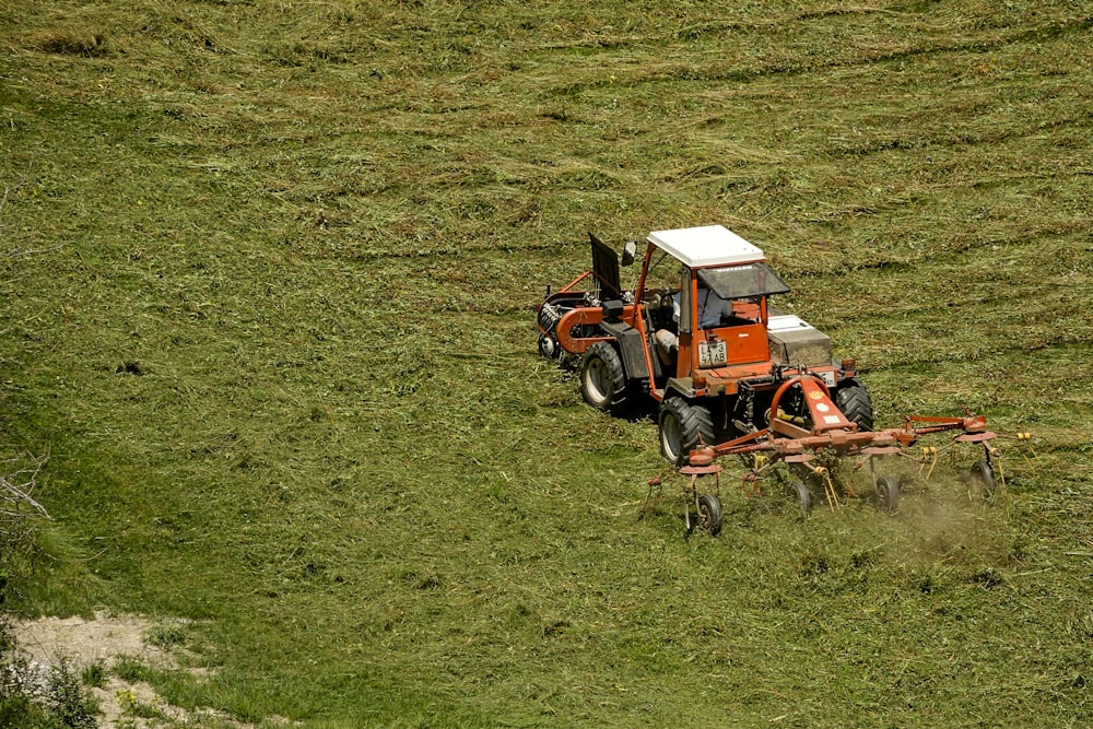 orange and white tractor on field