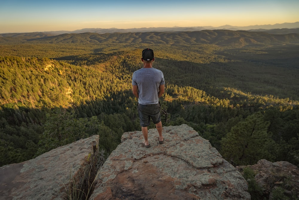 man standing on rock formation