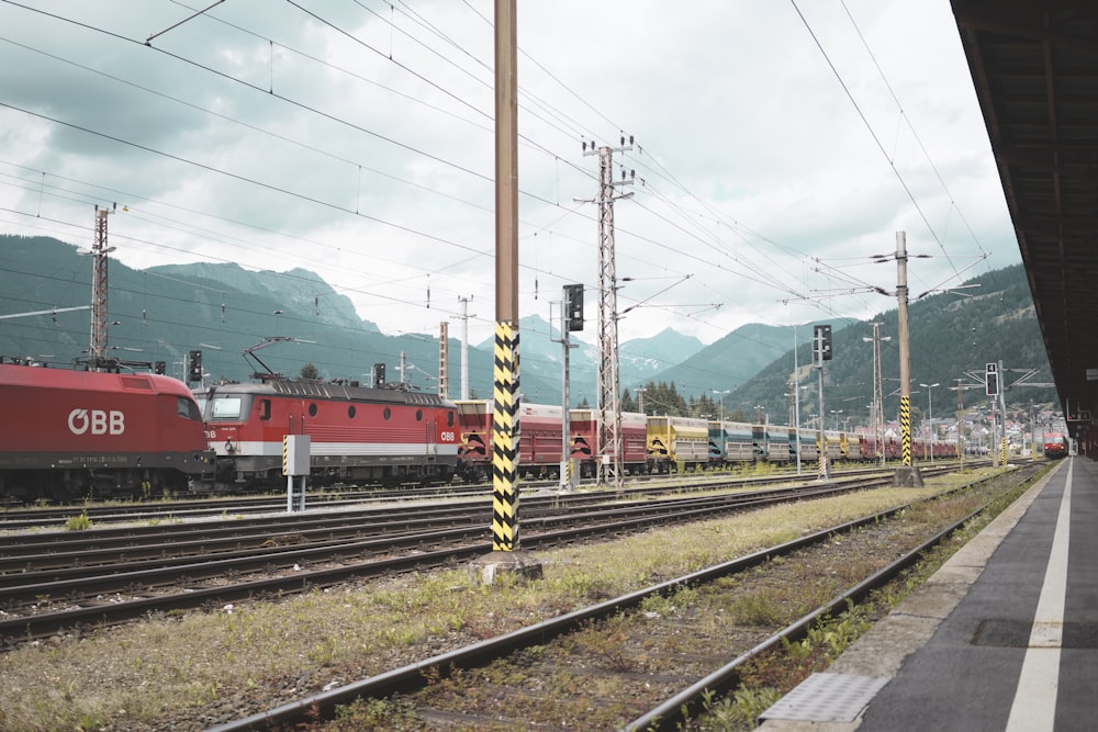 red train under white clouds