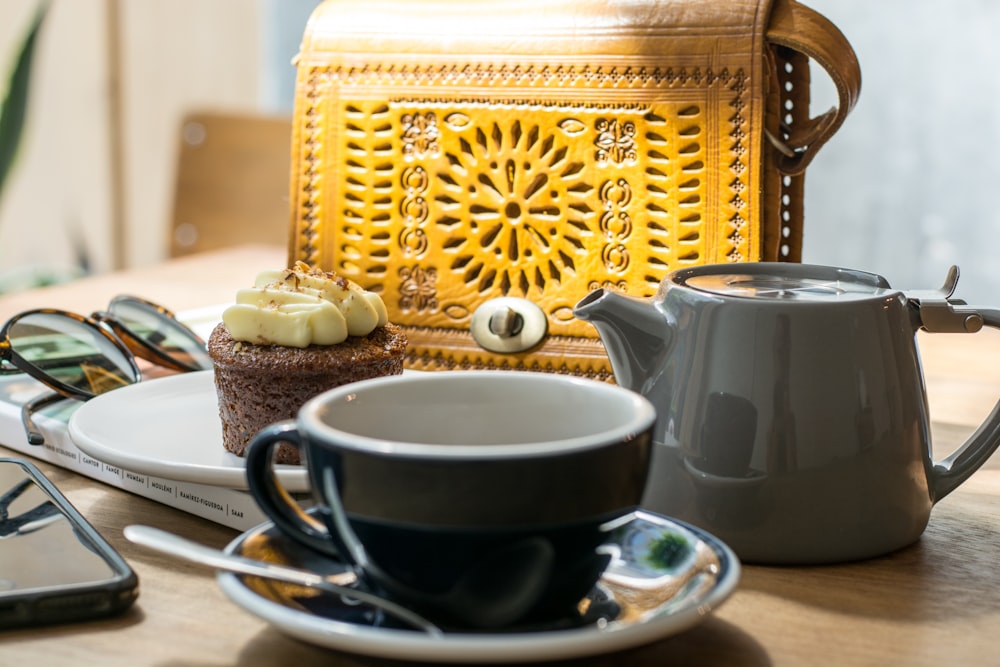gray teapot with teacup