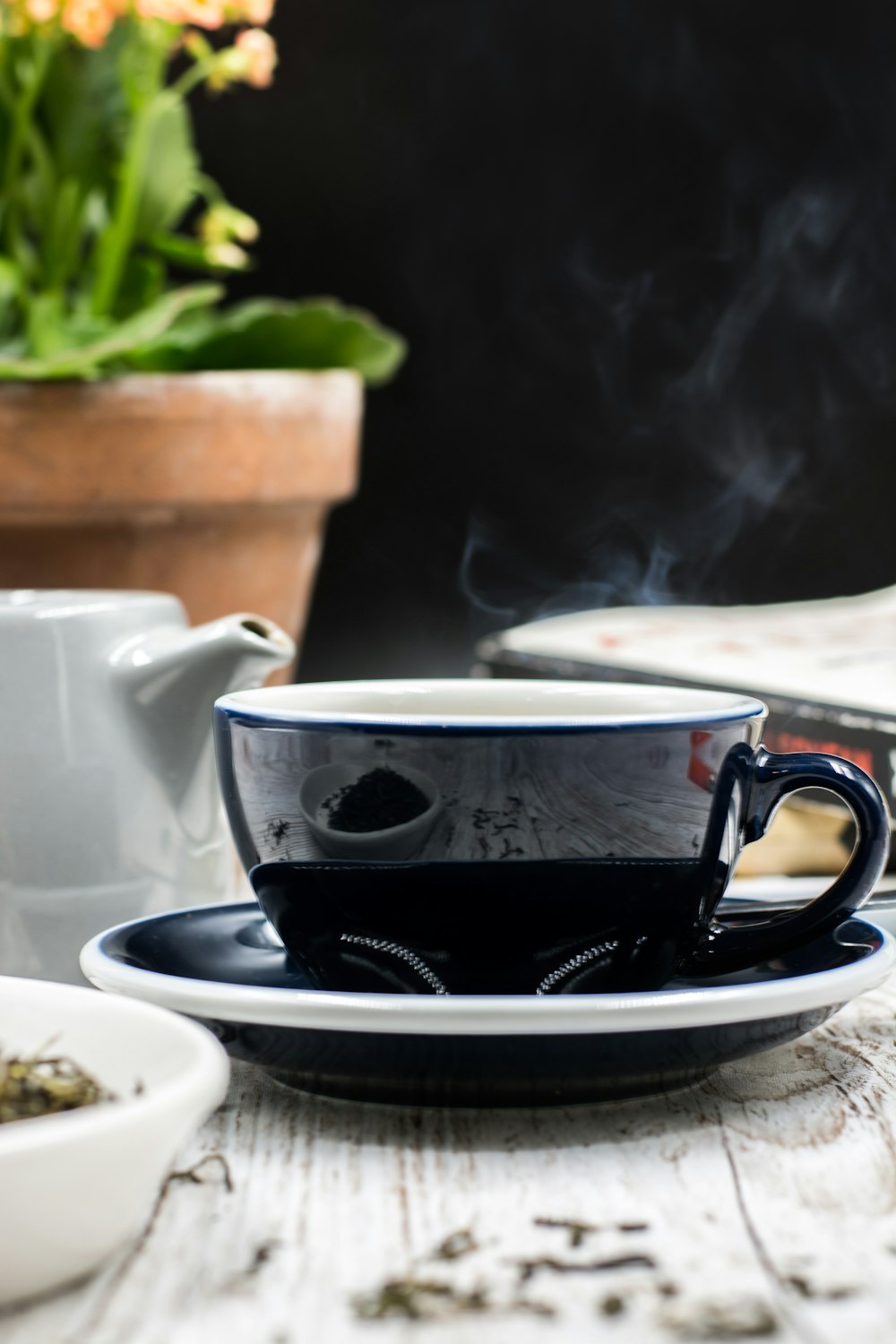 black ceramic teacup and saucer