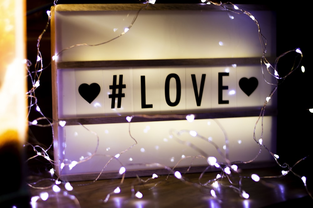 white #love signage turned-on in room