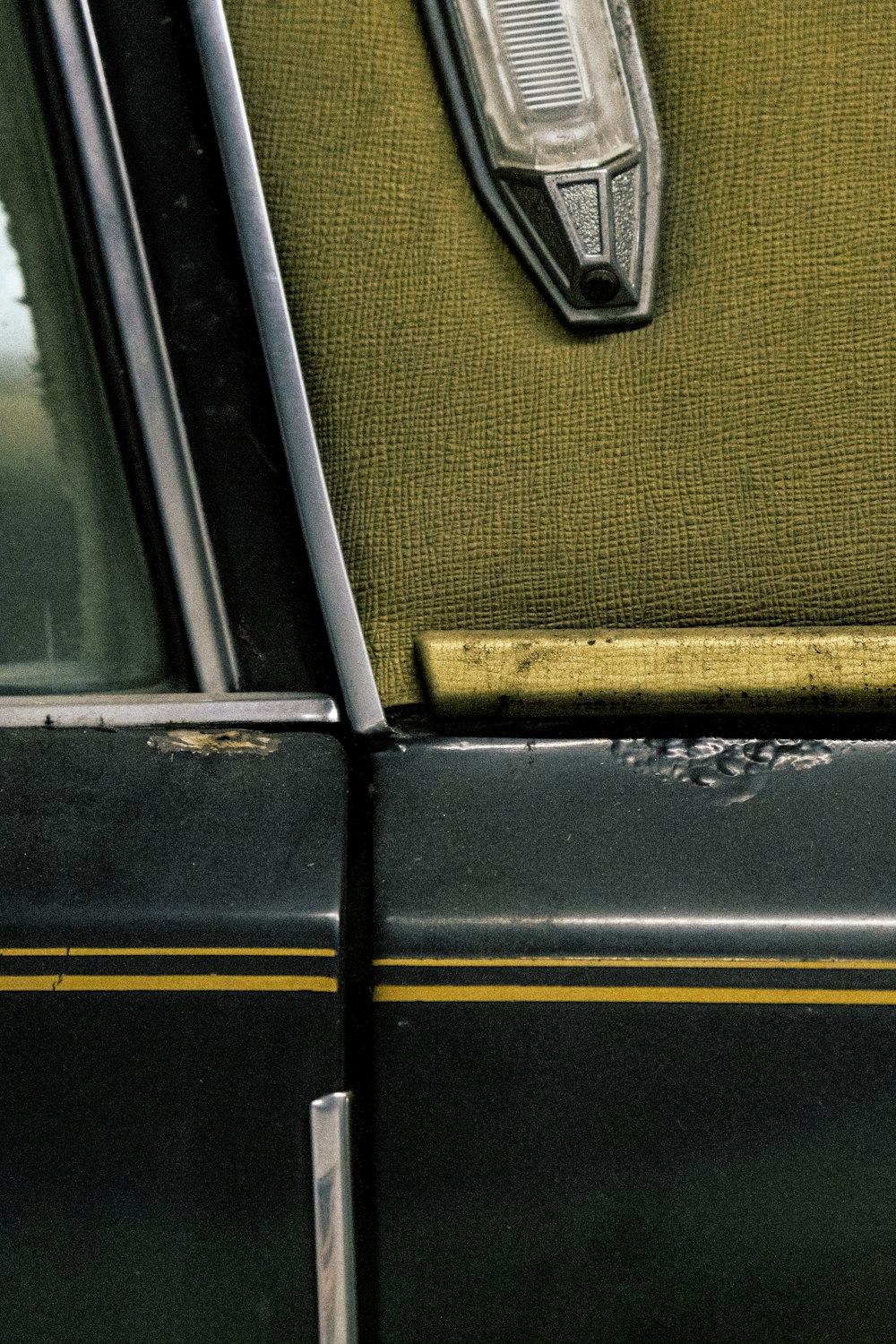 a close up of a piece of luggage on the back of a car