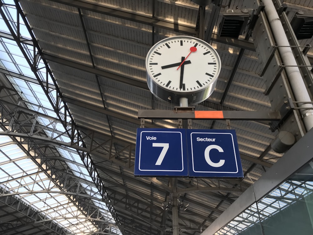 grey and white clock in a building close-up photography