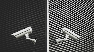 two grey CCTV cameras