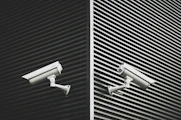 two grey CCTV cameras