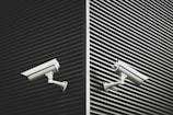 two grey CCTV cameras