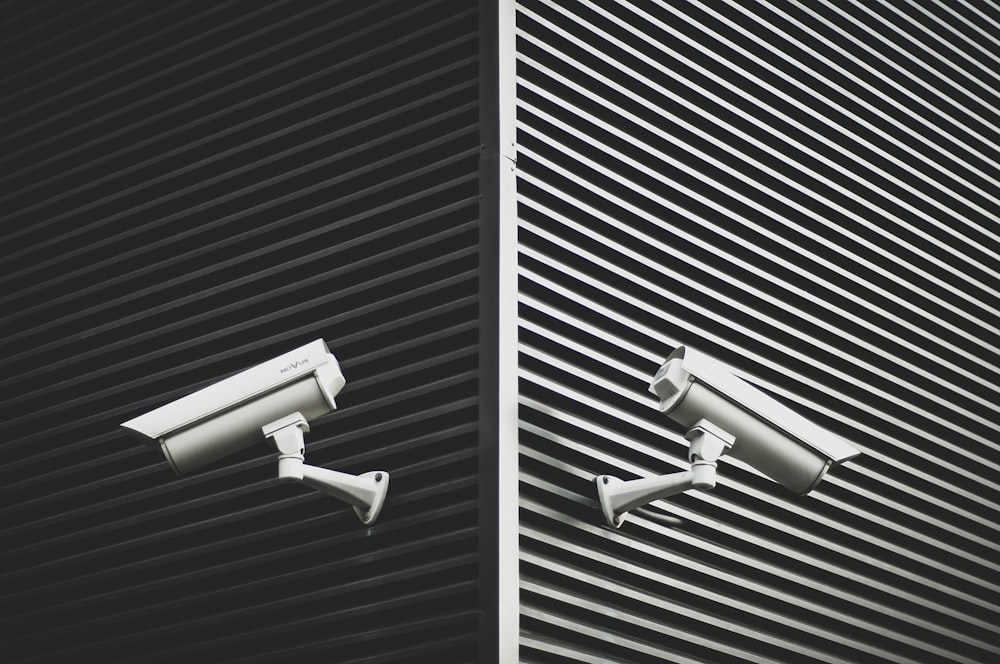 two grey CCTV cameras