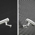 two grey CCTV cameras