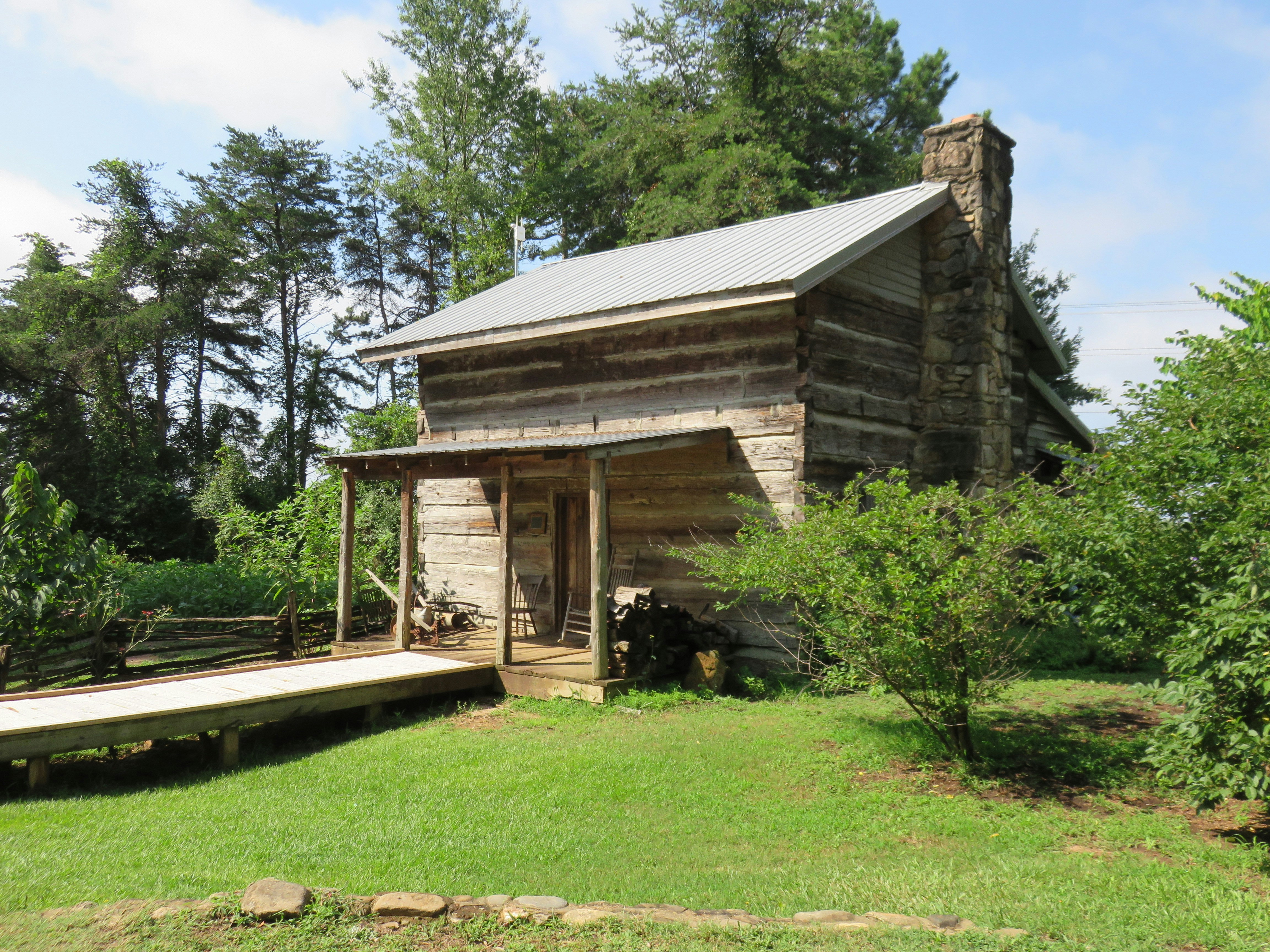 brown wooden house beside trees