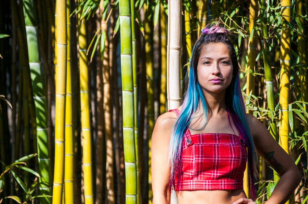 standing woman beside bamboo plants