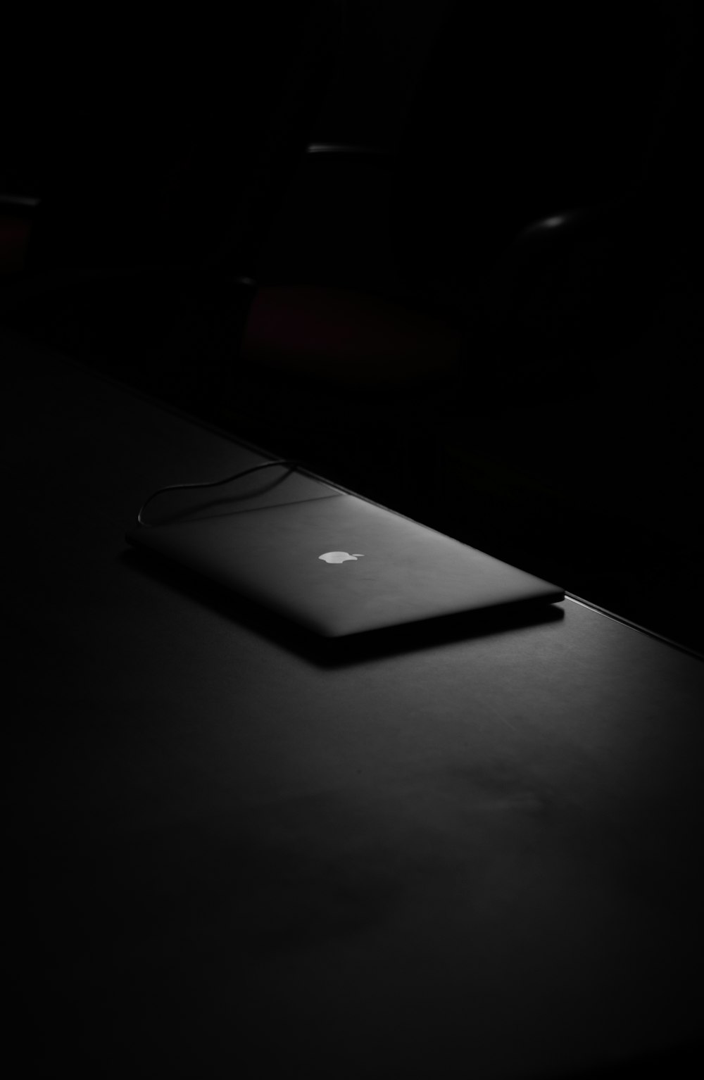 MacBook on table inside dark room