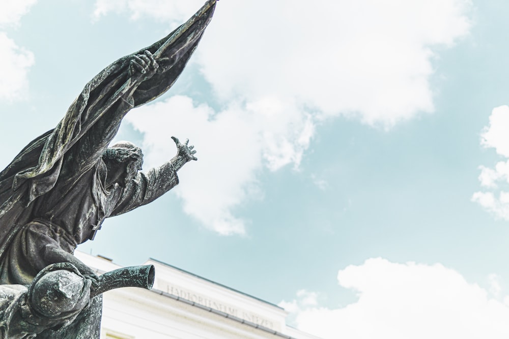 man holding black flag concrete statue close-up photography