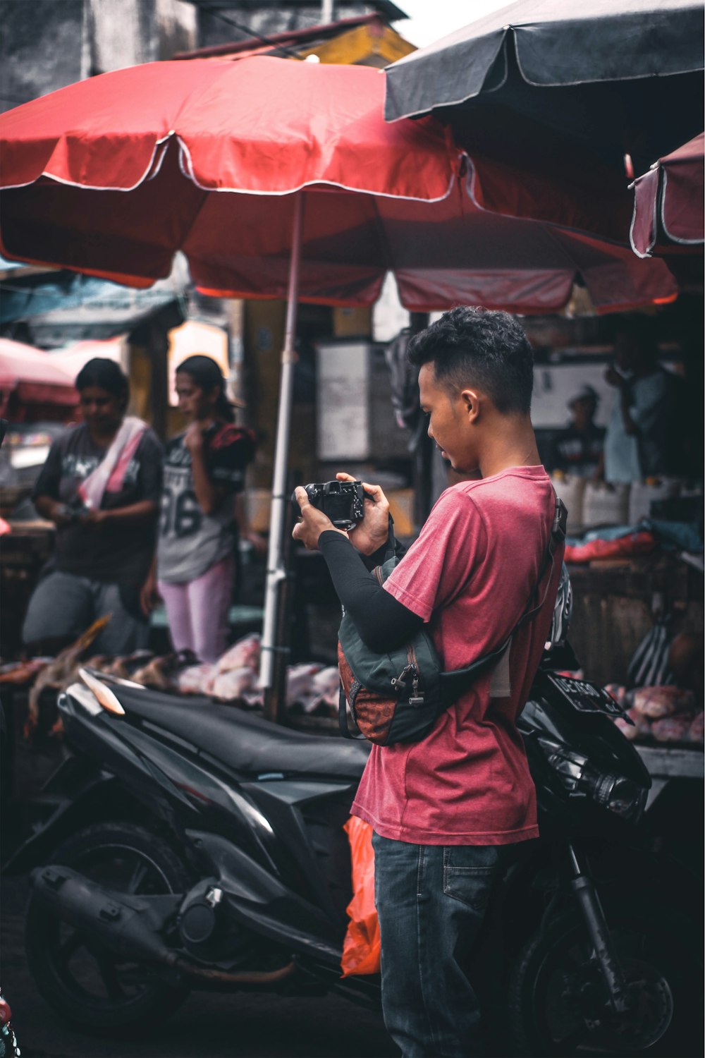 shallow focus photo of man using black DSLR camera