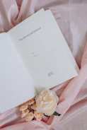 open book on pink textile