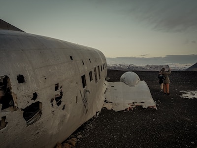Historic airplane wreckage site in the Andes mountains with surrounding snowy peaks.