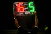 A printed player list held by a team captain before a match.