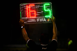 A tactical football match analysis board with player formations and stats.