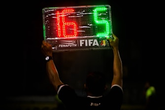 man wearing black polo shirt holding LED signage