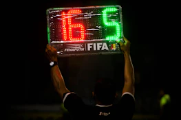 A printed player list held by a team captain before a match.