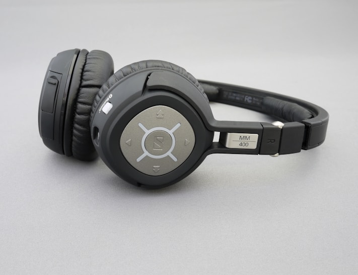 Over-ear wireless headphones with a sleek, modern design featuring circular ear cups with button controls and padding for comfort. The brand logo is visible on the ear cup, and the model number 'MM 400' is labeled on the headband.