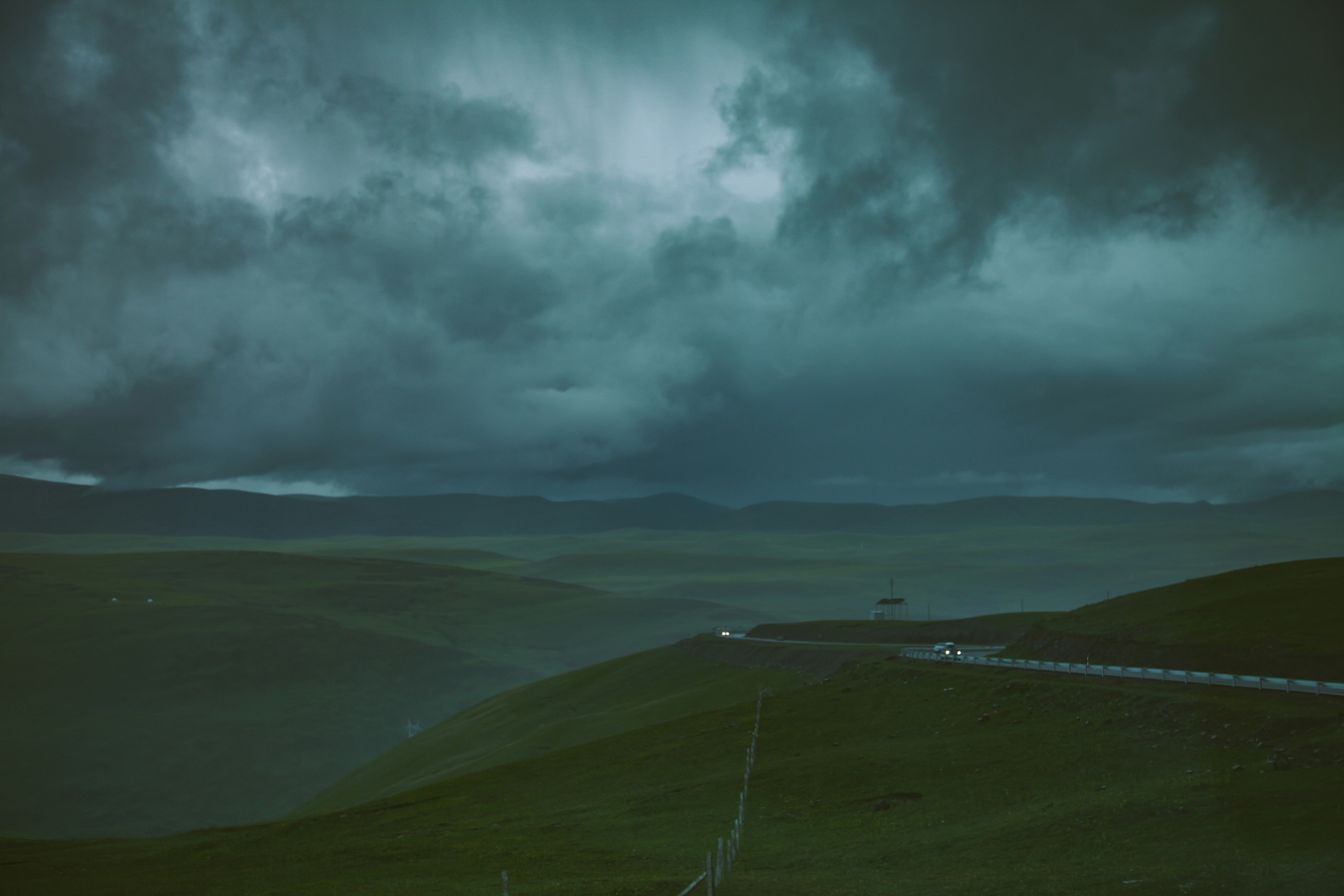 high-angle photography of mountain under nimbus clouds