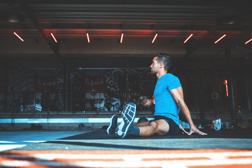 man sitting on exercise mat