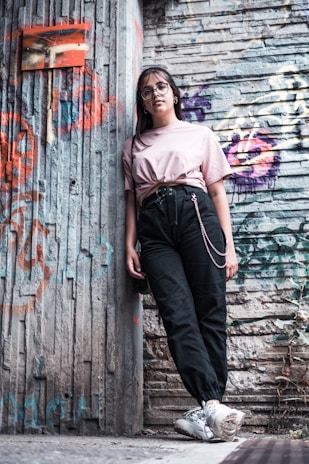 Young people wearing bold street style outfits from zynixs in an urban graffiti setting