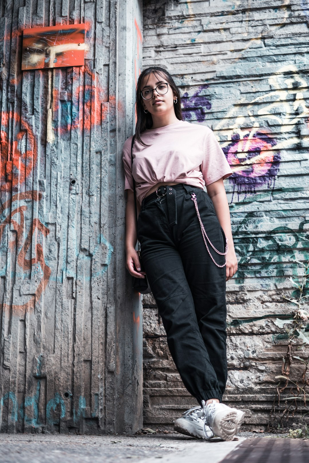 woman standing and leaning on wall