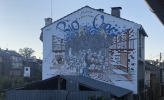 Group of local artists working together on a mural with symbolic motifs.