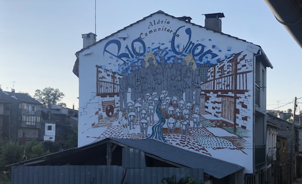 Group of local artists working together on a mural with symbolic motifs.
