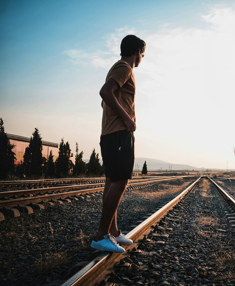 man standing on railings