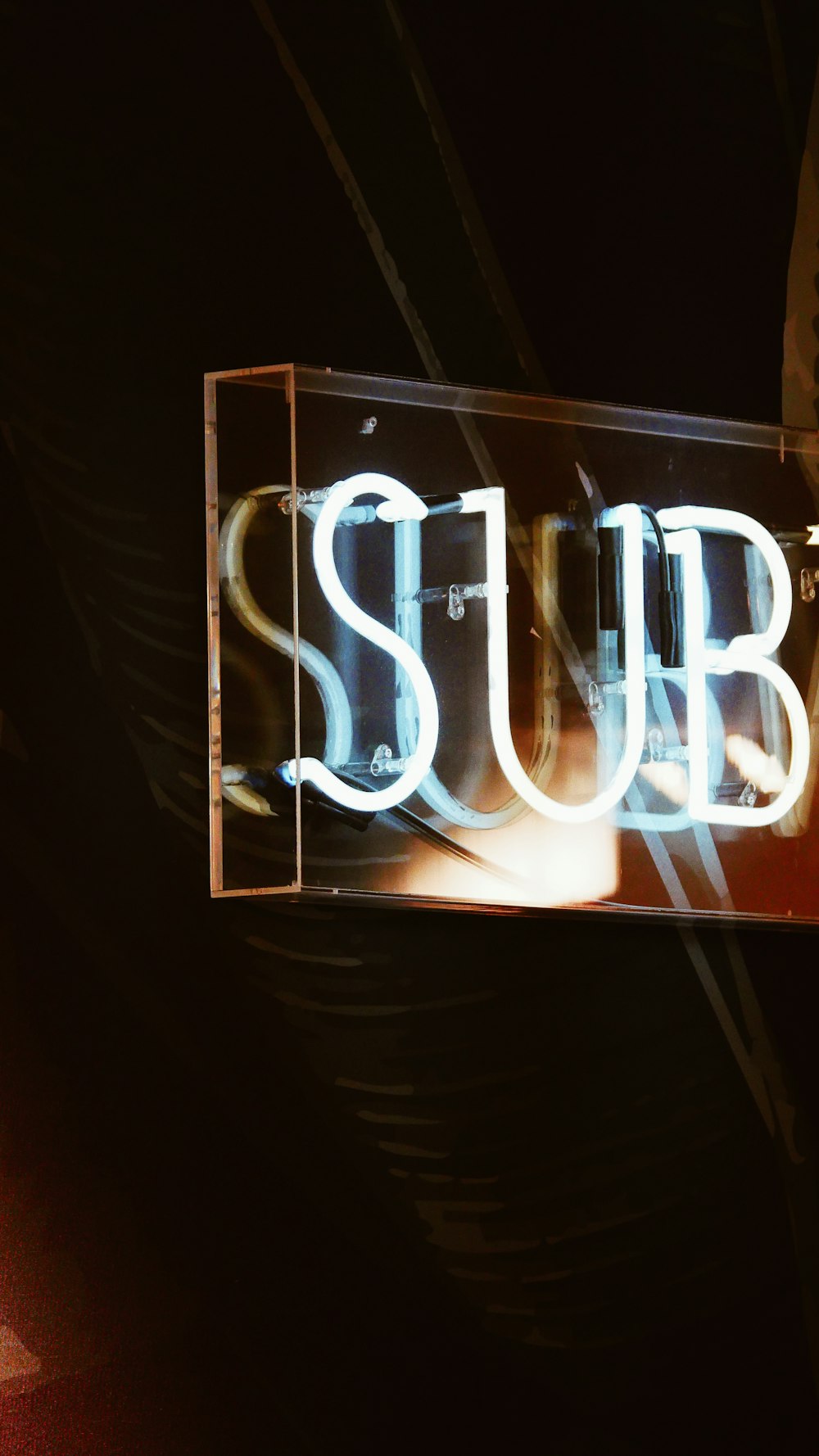 a neon sign that says sub above it