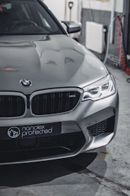 A sleek car coated with ceramic treatment shining under sunlight.