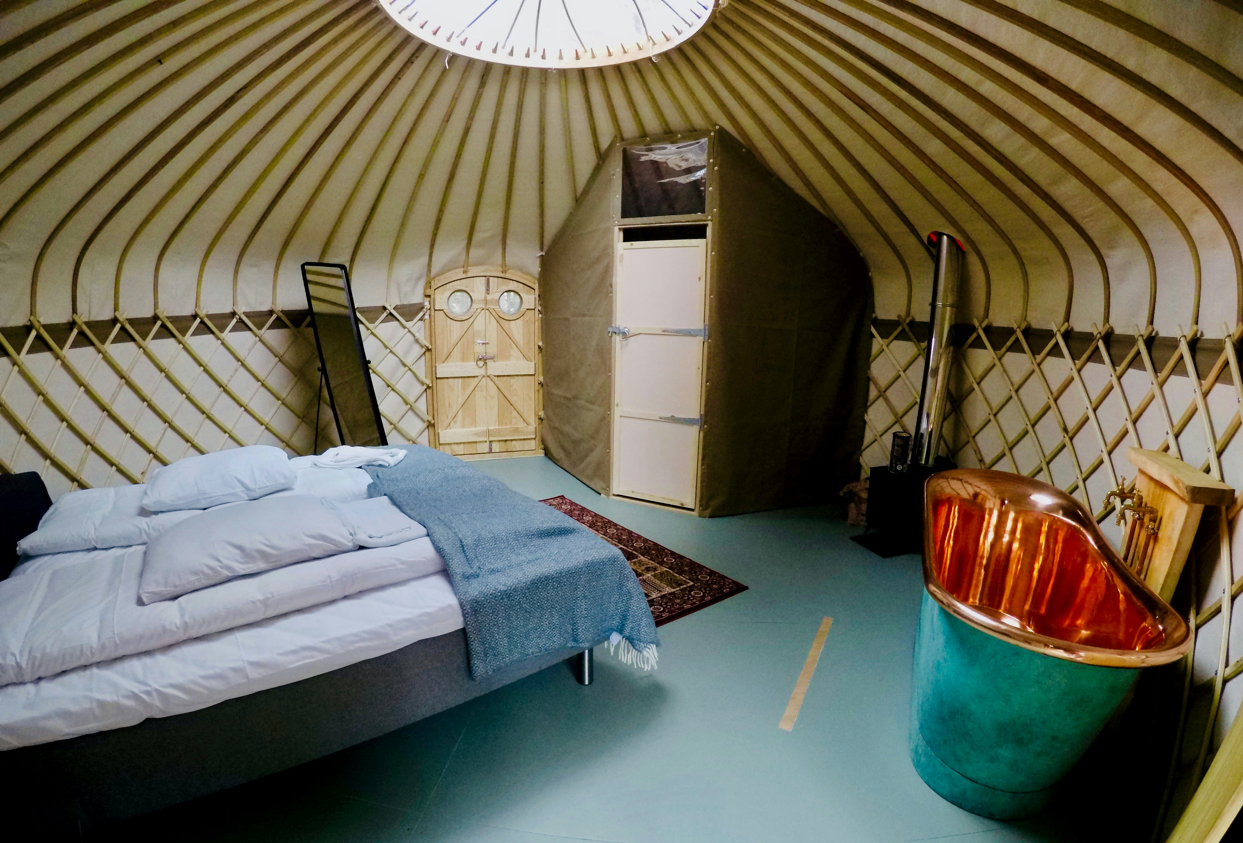 sleep setup inside a dome-shaped tent